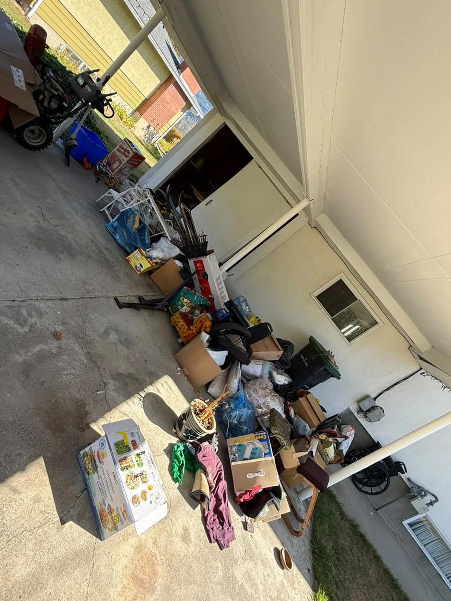 Household items gathered under a carport