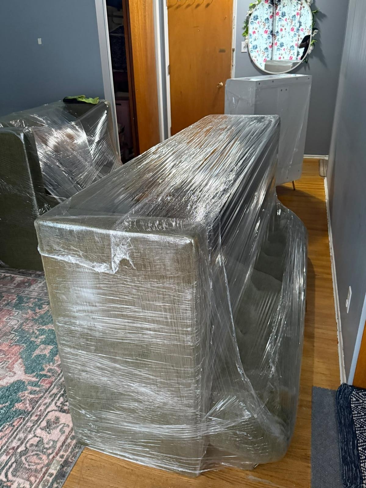 Wrapped sofa and household furniture prepared for a West Kootenay move.