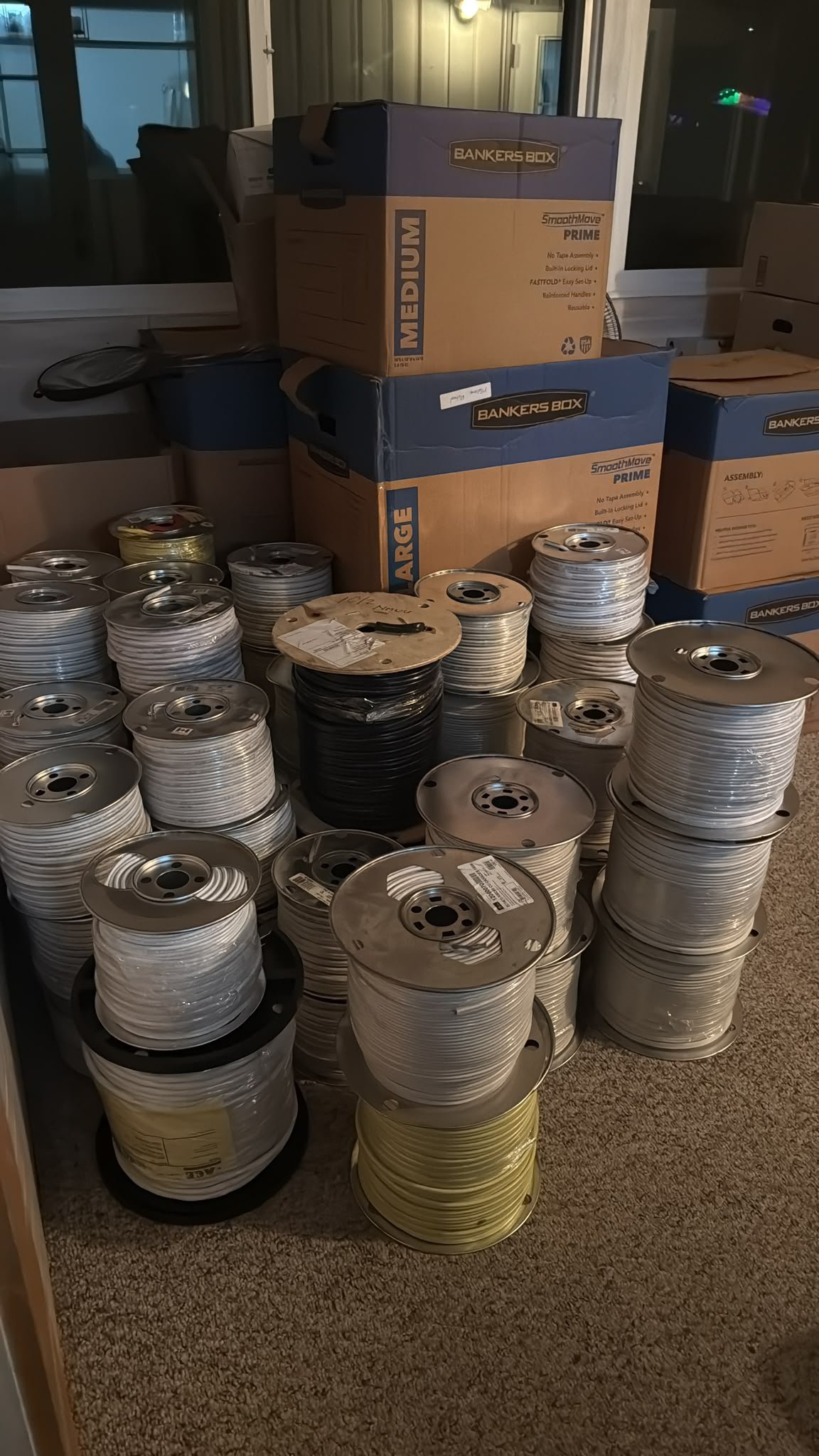 Wire spools and boxed supplies loaded inside the truck for a Nelson to Kelowna move.